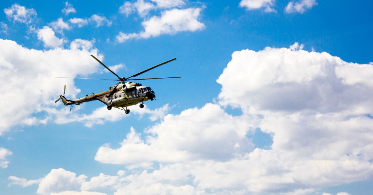 a helicopter flying in the air on a cloudy day